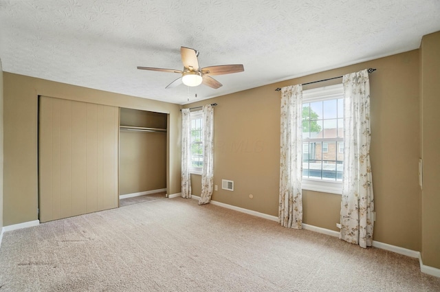 662 Pamlico St Unit Z7, Columbus, OH 43228 - unfurnished bedroom featuring a closet, carpet floors, baseboards, a textured ceiling, and ceiling fan