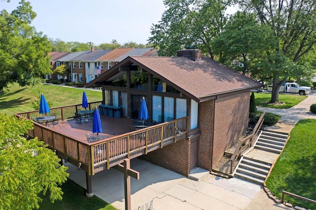 662 Pamlico St Unit Z7, Columbus, OH 43228 - rear view of house featuring brick siding, a shingled roof, a wooden deck, and outdoor dining area