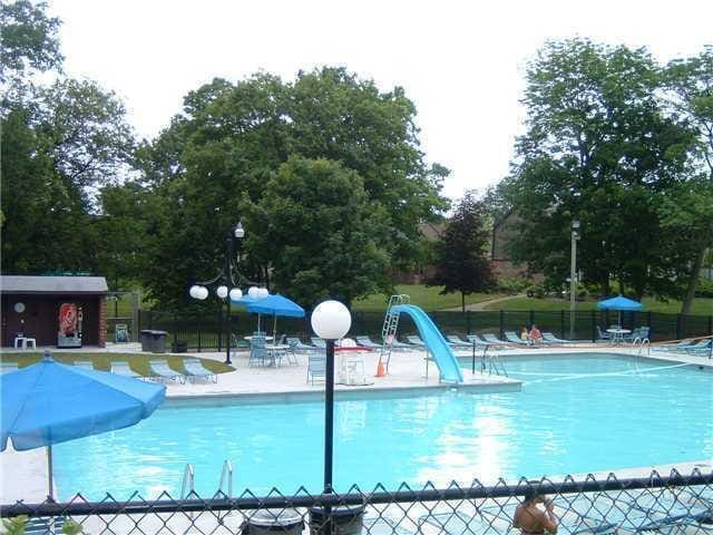662 Pamlico St Unit Z7, Columbus, OH 43228 - community pool featuring fence, a patio area, a water slide, and view of scattered trees