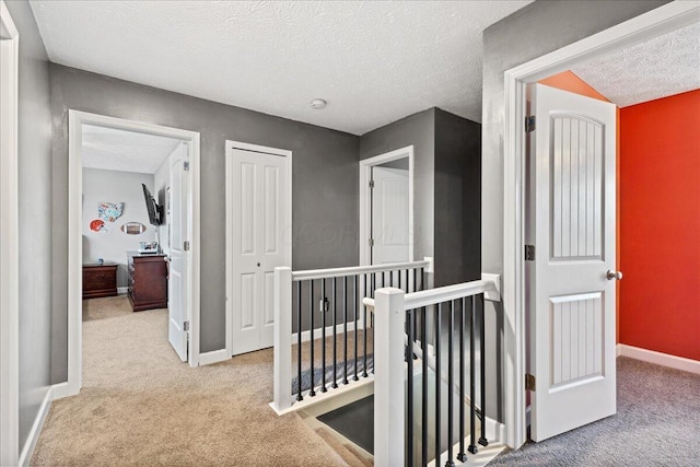 2460 N Court St, Circleville, OH 43113 - hall with an upstairs landing, carpet, a textured ceiling, and baseboards