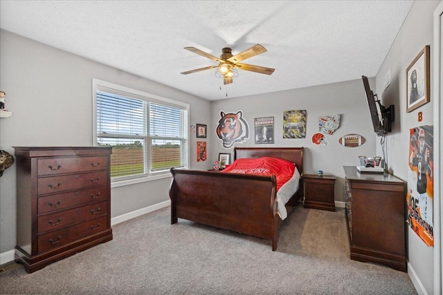 2460 N Court St, Circleville, OH 43113 - carpeted bedroom featuring baseboards, a textured ceiling, and a ceiling fan