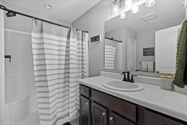 2460 N Court St, Circleville, OH 43113 - bathroom with a textured ceiling, vanity, and curtained shower