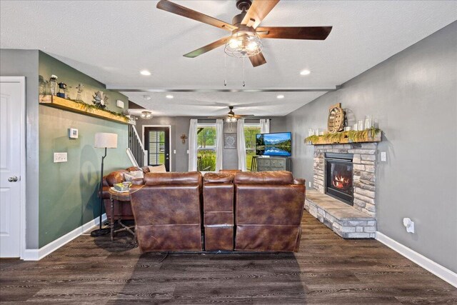 2460 N Court St, Circleville, OH 43113 - living room featuring a ceiling fan, wood finished floors, a stone fireplace, baseboards, and stairway