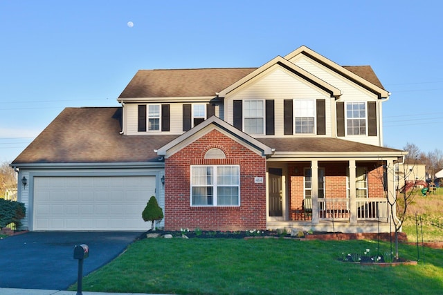 464 Highbanks Valley Dr, Newark, OH 43055 - view of front of house with asphalt driveway, covered porch, brick siding, an attached garage, and a front lawn