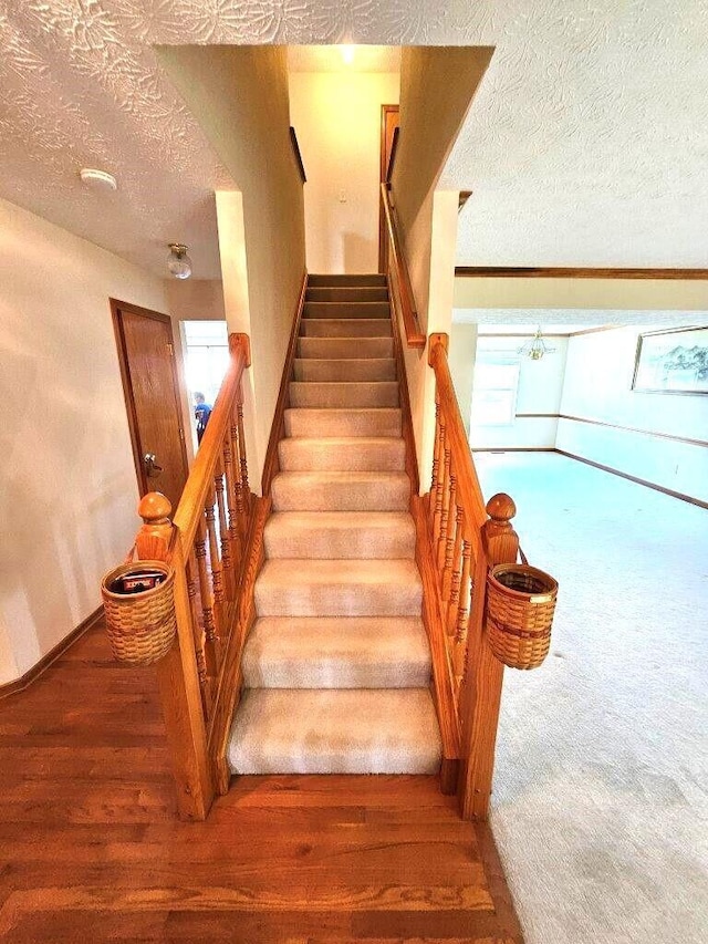 464 Highbanks Valley Dr, Newark, OH 43055 - staircase with a textured ceiling, baseboards, wood finished floors, and carpet