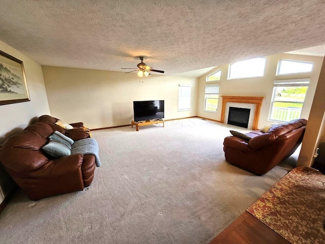 464 Highbanks Valley Dr, Newark, OH 43055 - living area featuring ceiling fan, a fireplace with flush hearth, a textured ceiling, lofted ceiling, and baseboards