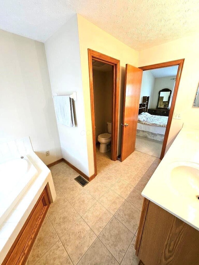 464 Highbanks Valley Dr, Newark, OH 43055 - full bathroom with toilet, vanity, ensuite bathroom, tile patterned flooring, and a textured ceiling