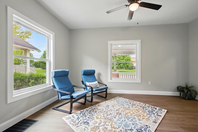 living area with healthy amount of natural light and baseboards