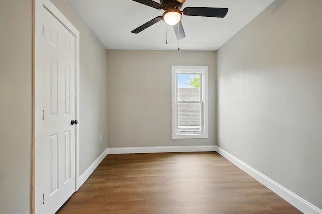 unfurnished bedroom with baseboards, wood finished floors, and ceiling fan