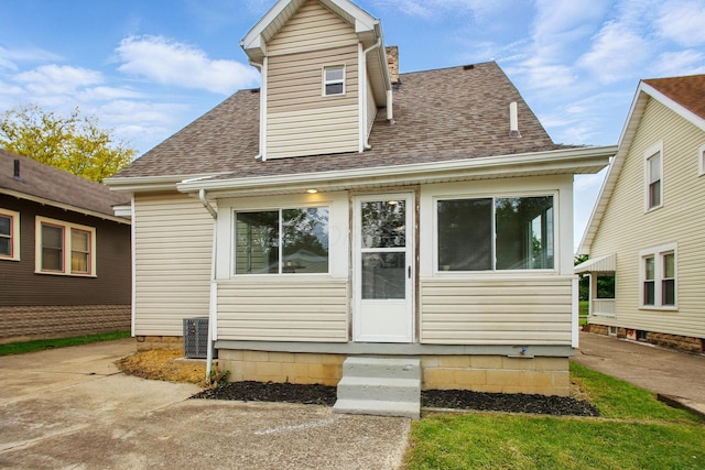 back of property featuring roof with shingles, cooling unit, and entry steps