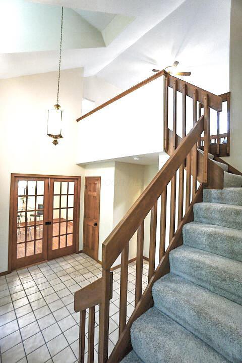 532 Woodview Rd, Westerville, OH 43081 - stairs with high vaulted ceiling, ceiling fan, tile patterned floors, french doors, and baseboards