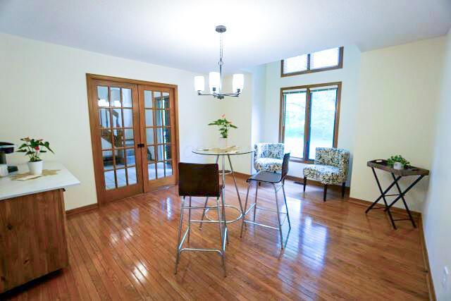 532 Woodview Rd, Westerville, OH 43081 - living area with french doors, wood finished floors, a chandelier, and baseboards