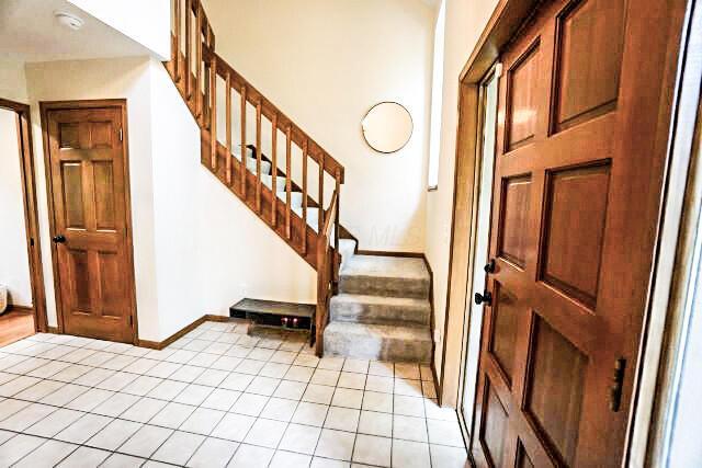 532 Woodview Rd, Westerville, OH 43081 - entryway featuring light tile patterned floors, stairway, and baseboards