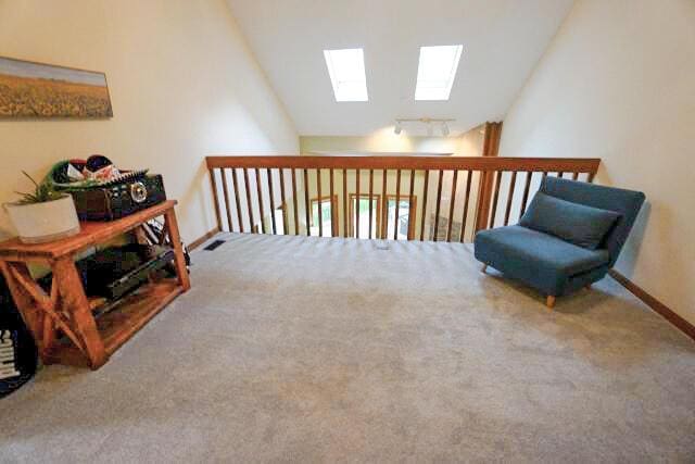 532 Woodview Rd, Westerville, OH 43081 - sitting room featuring a skylight, vaulted ceiling, carpet floors, and baseboards