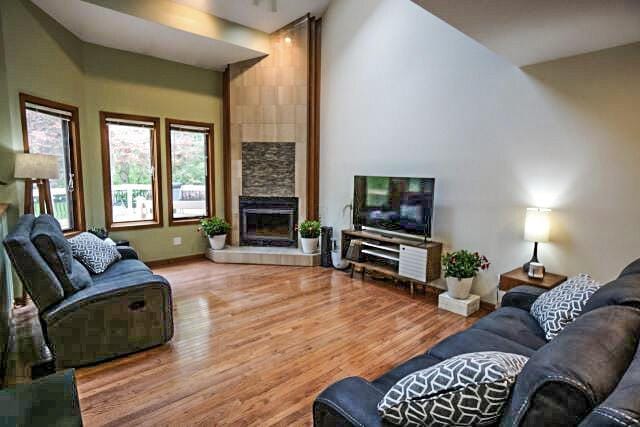 532 Woodview Rd, Westerville, OH 43081 - living area with wood finished floors, a fireplace, high vaulted ceiling, and baseboards