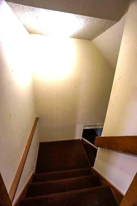 532 Woodview Rd, Westerville, OH 43081 - stairway with a textured ceiling and lofted ceiling