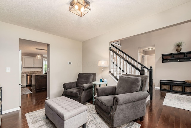 4381 Grathrine Ct, Lewis Center, OH 43035 - living area featuring dark wood-style flooring, stairs, baseboards, and a textured ceiling