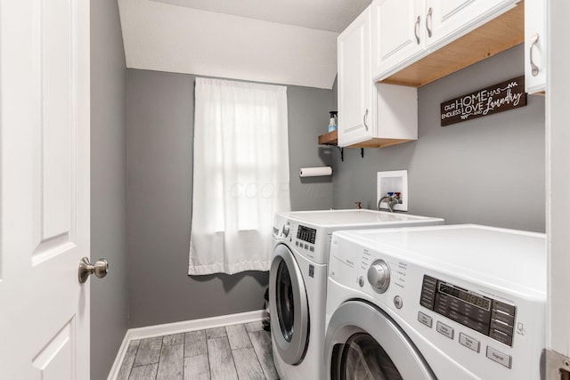 4381 Grathrine Ct, Lewis Center, OH 43035 - laundry area with independent washer and dryer, cabinet space, light wood-style floors, and baseboards