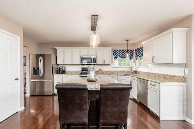 4381 Grathrine Ct, Lewis Center, OH 43035 - kitchen with appliances with stainless steel finishes, a sink, dark wood-style flooring, tasteful backsplash, and white cabinets