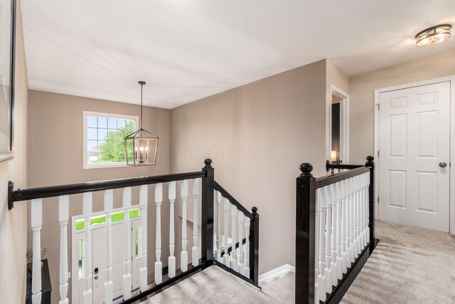4381 Grathrine Ct, Lewis Center, OH 43035 - corridor featuring an upstairs landing, a chandelier, carpet flooring, and baseboards