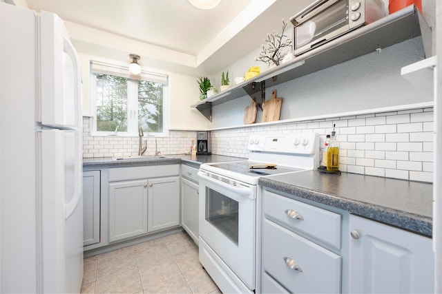 651 Eastern Ave, Bellefontaine, OH 43311 - kitchen with white appliances, open shelves, a sink, dark countertops, and decorative backsplash