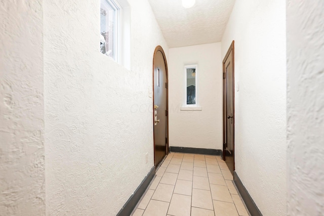 651 Eastern Ave, Bellefontaine, OH 43311 - hallway with a textured ceiling, a textured wall, and light tile patterned floors