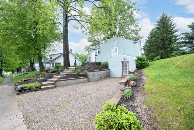 651 Eastern Ave, Bellefontaine, OH 43311 - view of side of home featuring stucco siding and a lawn