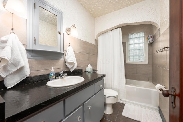 651 Eastern Ave, Bellefontaine, OH 43311 - bathroom with toilet, a textured wall, tile patterned floors, vanity, and shower / bath combination with curtain