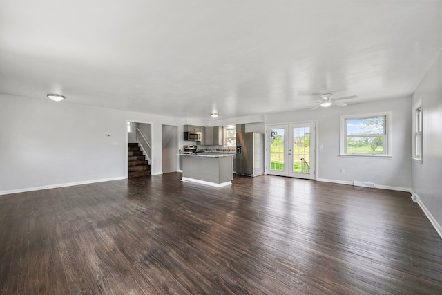 86 Arlington Ave, London, OH 43140 - unfurnished living room with dark wood-style flooring, baseboards, stairs, and a ceiling fan