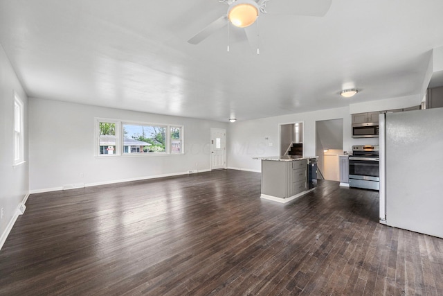 86 Arlington Ave, London, OH 43140 - unfurnished living room featuring dark wood finished floors, ceiling fan, and baseboards