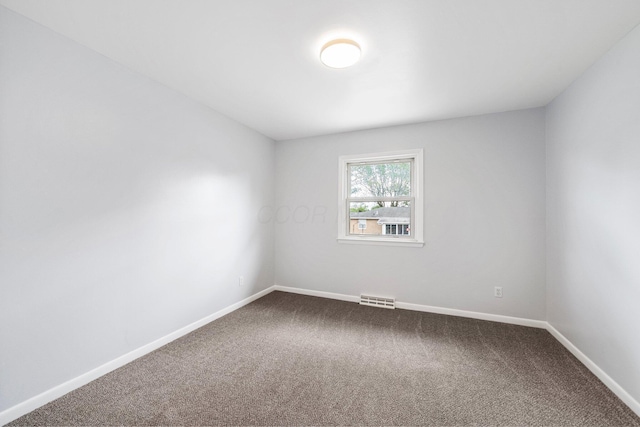 86 Arlington Ave, London, OH 43140 - empty room featuring dark colored carpet and baseboards