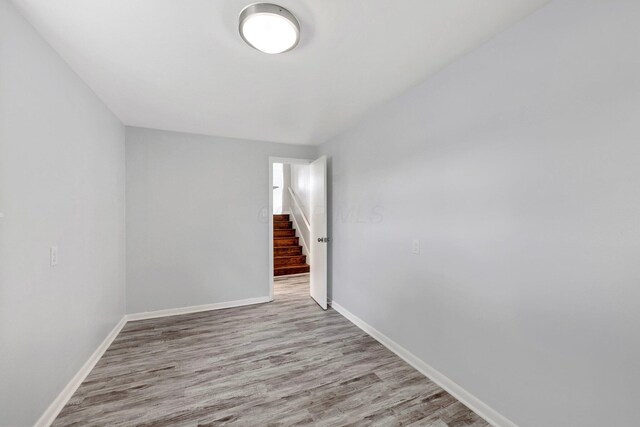 86 Arlington Ave, London, OH 43140 - spare room with wood finished floors, baseboards, and stairs