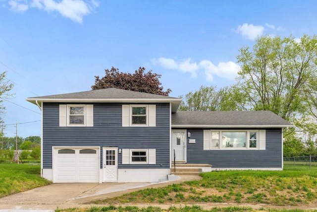 86 Arlington Ave, London, OH 43140 - tri-level home featuring a garage, driveway, fence, and a shingled roof