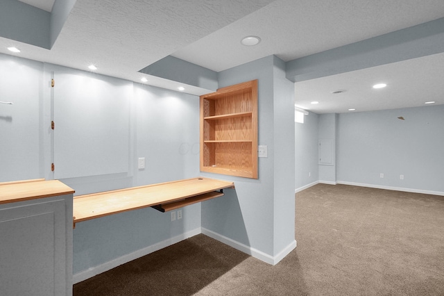 7209 Oliver Winchester Dr, Canal Winchester, OH 43110 - unfurnished office with dark carpet, recessed lighting, baseboards, built in desk, and a textured ceiling