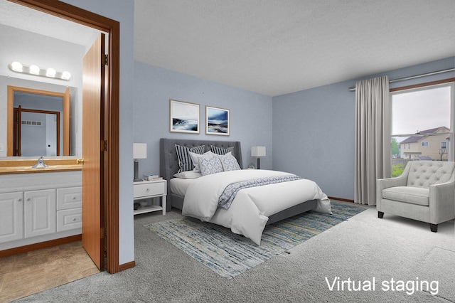 7209 Oliver Winchester Dr, Canal Winchester, OH 43110 - bedroom with carpet floors, a sink, connected bathroom, baseboards, and a textured ceiling