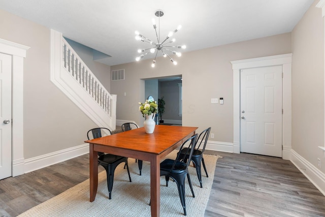 581 Kelton Ave, Columbus, OH 43205 - dining area with a chandelier, stairway, wood finished floors, and baseboards