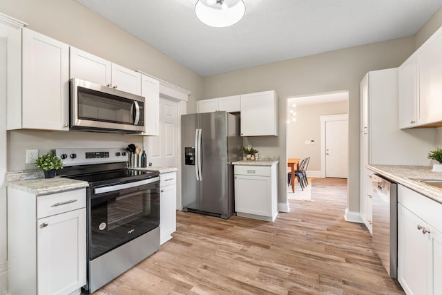 581 Kelton Ave, Columbus, OH 43205 - kitchen featuring stainless steel appliances, white cabinets, light wood-style flooring, and baseboards