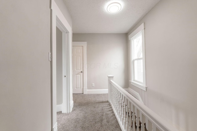 581 Kelton Ave, Columbus, OH 43205 - hall with carpet floors, an upstairs landing, a textured ceiling, and baseboards