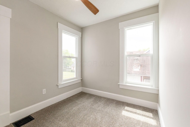 581 Kelton Ave, Columbus, OH 43205 - carpeted empty room featuring plenty of natural light, baseboards, and ceiling fan