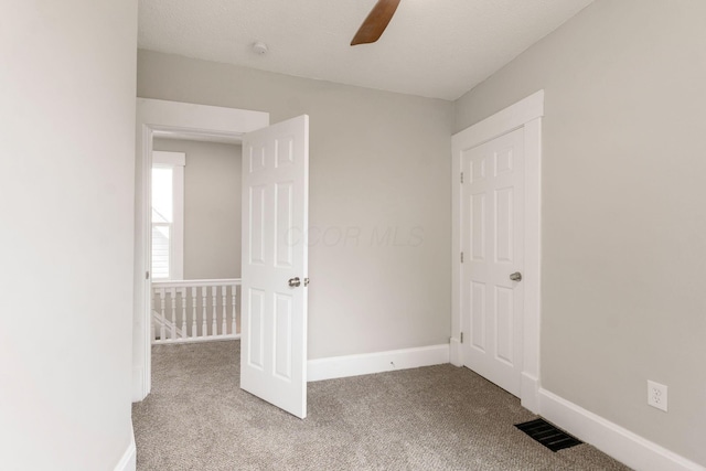 581 Kelton Ave, Columbus, OH 43205 - unfurnished bedroom with carpet, baseboards, and a ceiling fan