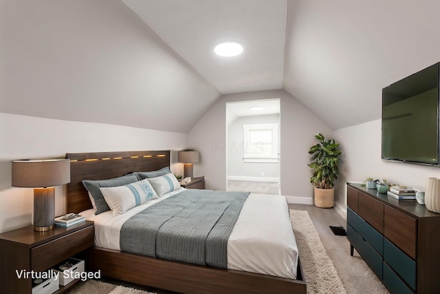 581 Kelton Ave, Columbus, OH 43205 - bedroom featuring baseboards, lofted ceiling, light colored carpet, and ensuite bathroom