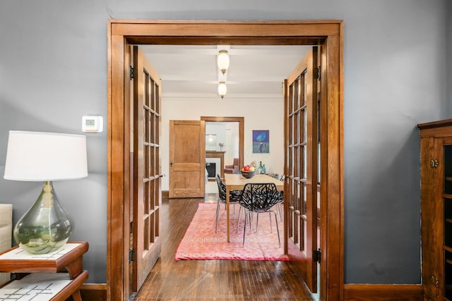 hallway with french doors and dark wood finished floors