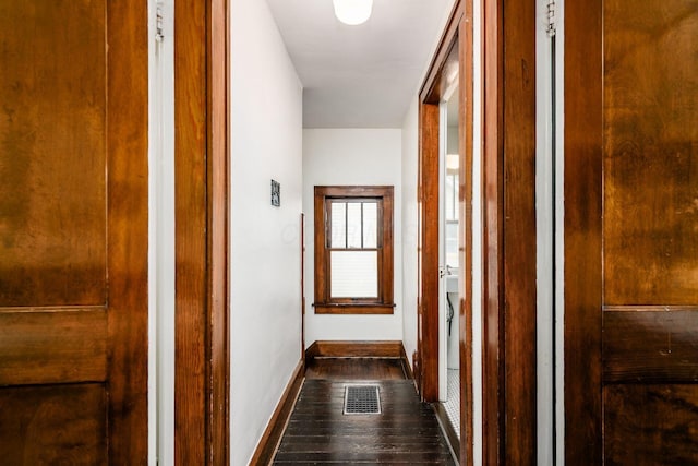 hall featuring dark wood-style floors and baseboards