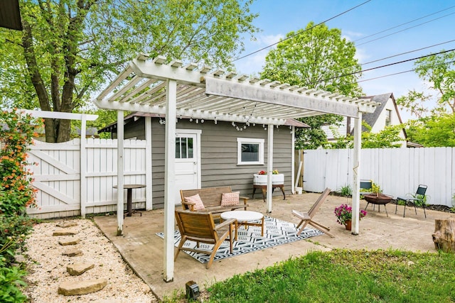 view of patio / terrace with a fire pit, a gate, fence, and a pergola