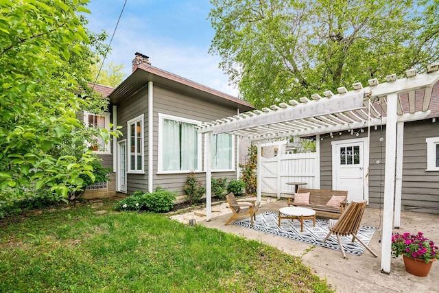 back of house featuring a pergola, a patio area, and a chimney