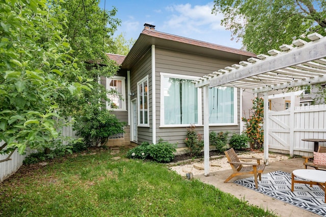 view of yard with fence, a pergola, and a patio area