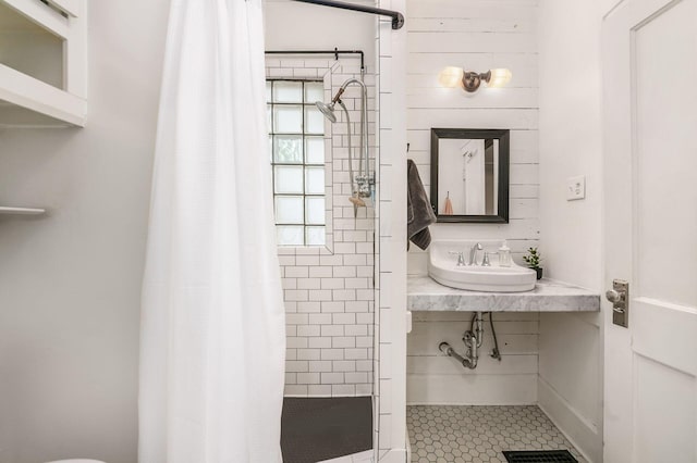235 E Kelso Rd, Columbus, OH 43202 - bathroom with a sink, a shower stall, and tile patterned floors