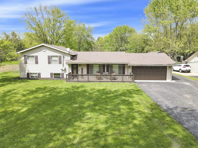 tri-level home featuring a garage, a front lawn, asphalt driveway, and a shingled roof