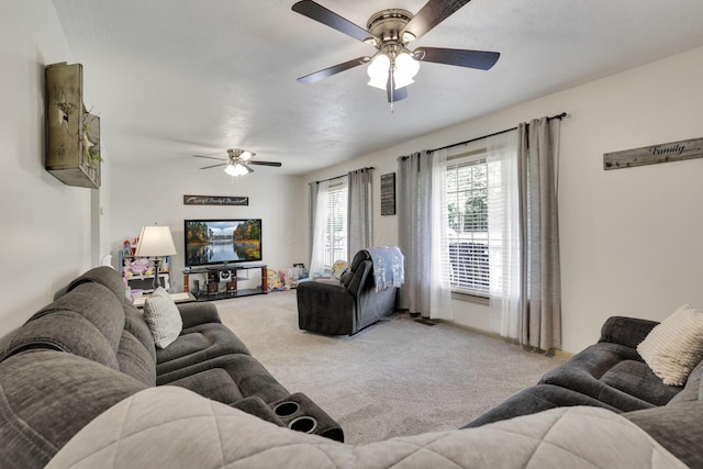 living room with a ceiling fan and light carpet