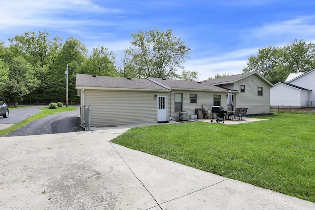 back of house with a patio, cooling unit, driveway, and a shingled roof